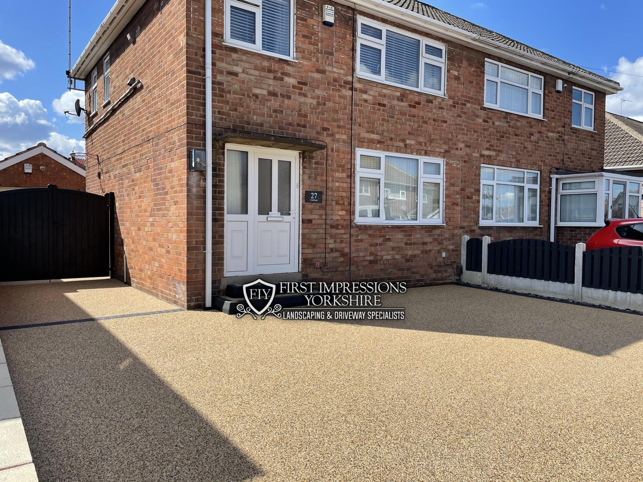 Sand coloured resin bound driveway wrapping around a semi detached house