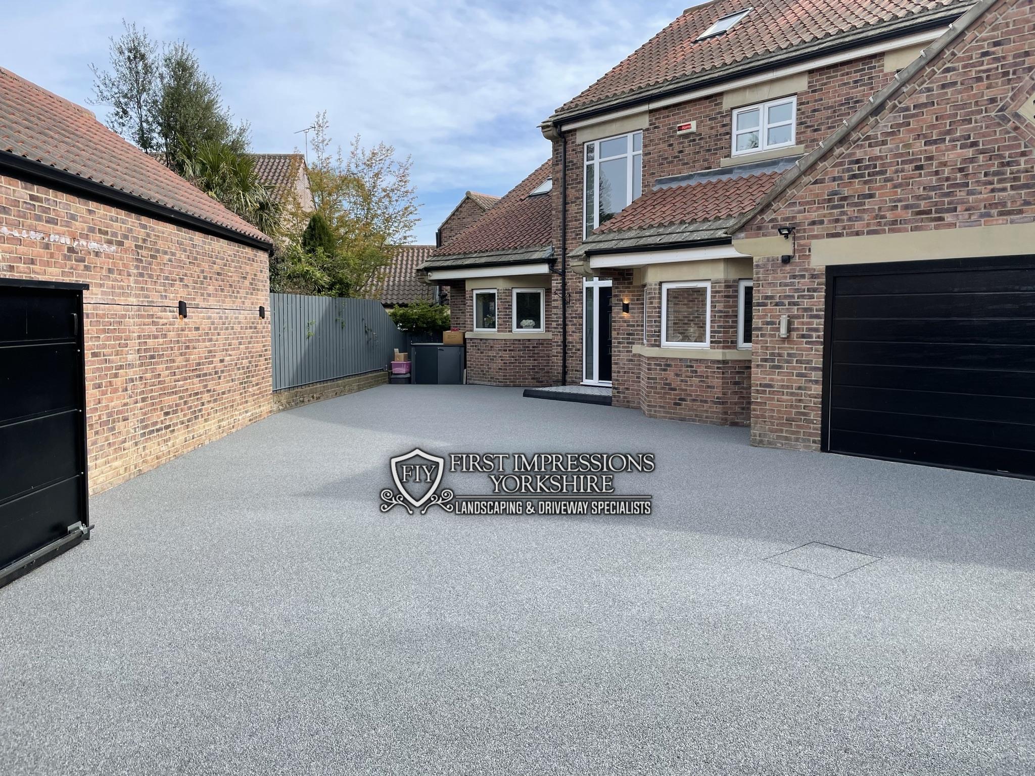 Resin bound driveway and courtyard between a house and detached garage