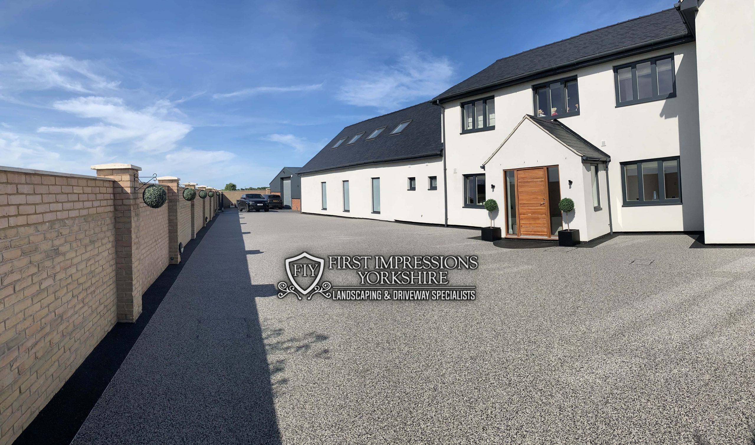 Silver resin bound driveway and path running the length of a house